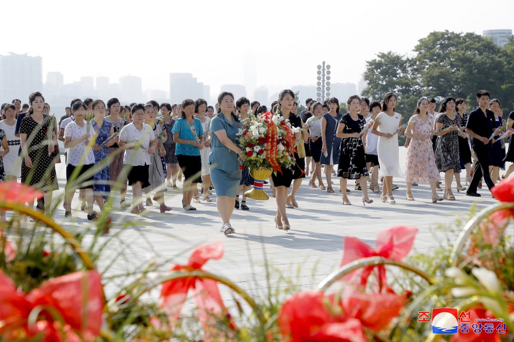 Floral Tribute Paid to Statues of President Kim Il Sung and Chairman Kim Jong Il